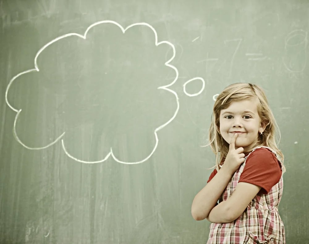 Cheerful kids at school room having education activity on chalkboard