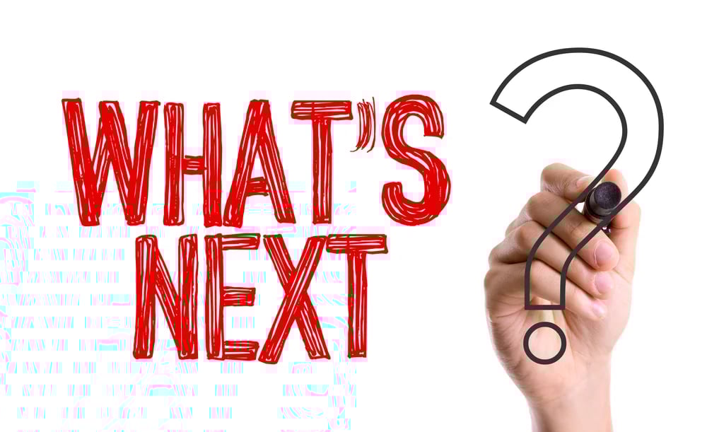 Hand with marker writing the question Whats Next_
